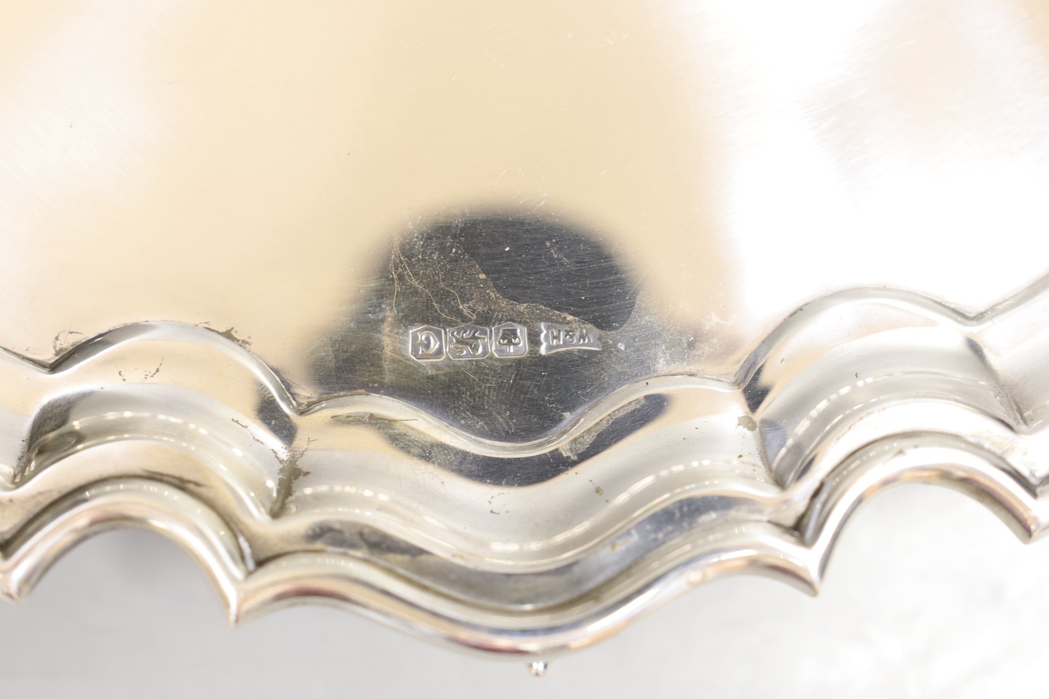 A George VI silver salver, on scroll feet, Walker & Hall, Sheffield, 1949, 31.2cm, 27.2oz.